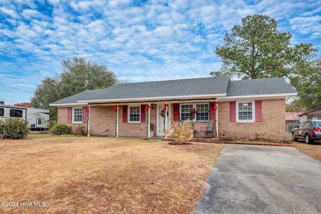 ranch-style house with a front yard and a porch