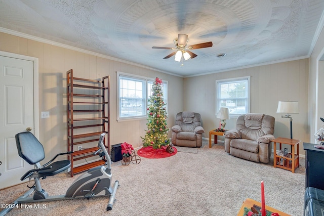 recreation room with crown molding, carpet floors, and ceiling fan