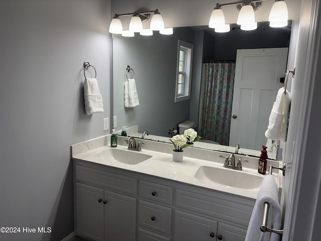 full bathroom featuring double vanity and a sink