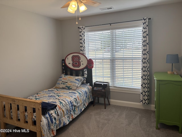 carpeted bedroom featuring a ceiling fan, baseboards, and visible vents