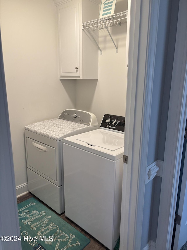 clothes washing area featuring cabinets and washing machine and dryer