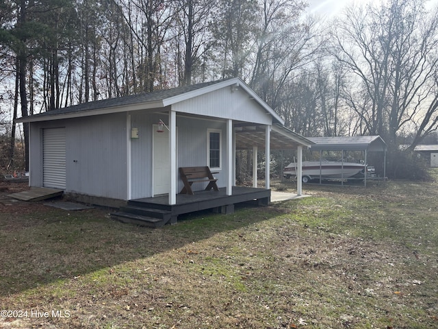 back of house with a carport and a yard