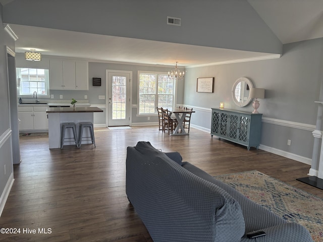 living area featuring visible vents, plenty of natural light, and dark wood-style floors