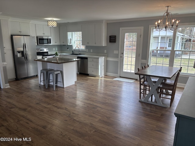 kitchen featuring appliances with stainless steel finishes, a center island, sink, and white cabinets