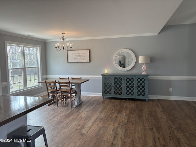 dining area featuring crown molding, dark wood-type flooring, and a chandelier