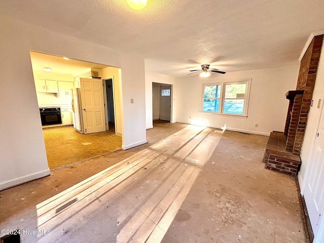 interior space featuring a textured ceiling and ceiling fan