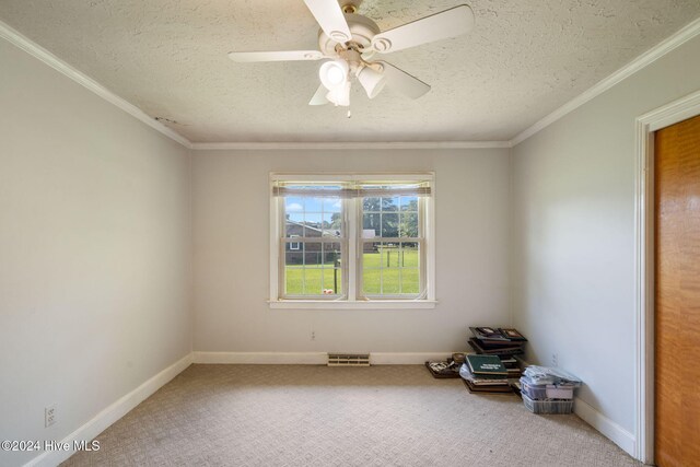 unfurnished room featuring ceiling fan, crown molding, a textured ceiling, and carpet flooring