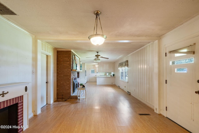 interior space featuring crown molding, wood-type flooring, and a textured ceiling