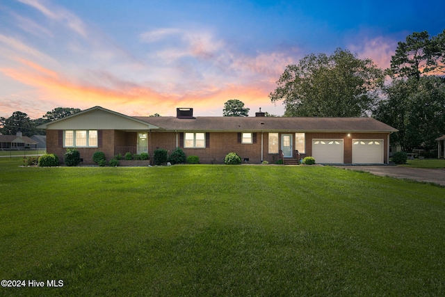 single story home featuring a garage and a front yard