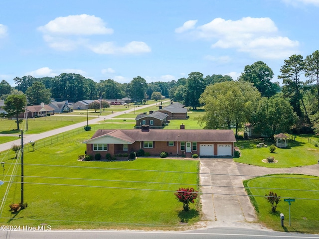 ranch-style home featuring a garage and a front lawn