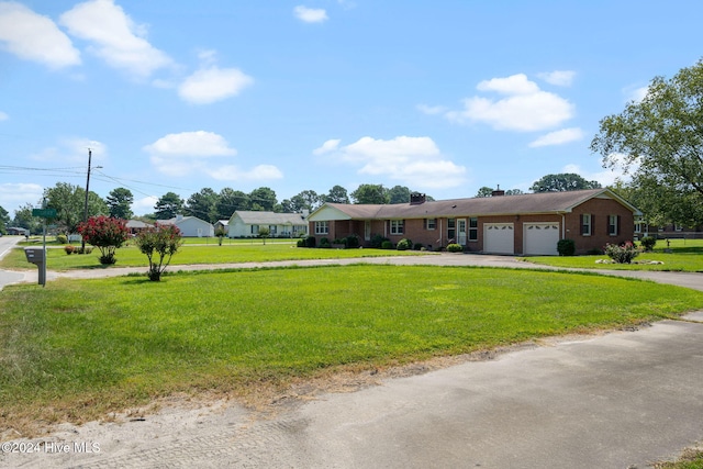 single story home featuring a garage and a front lawn