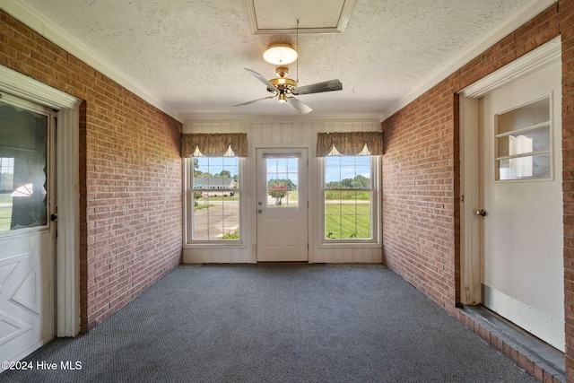 unfurnished sunroom with a wealth of natural light and ceiling fan