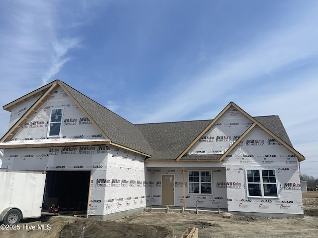 property in mid-construction featuring a shingled roof