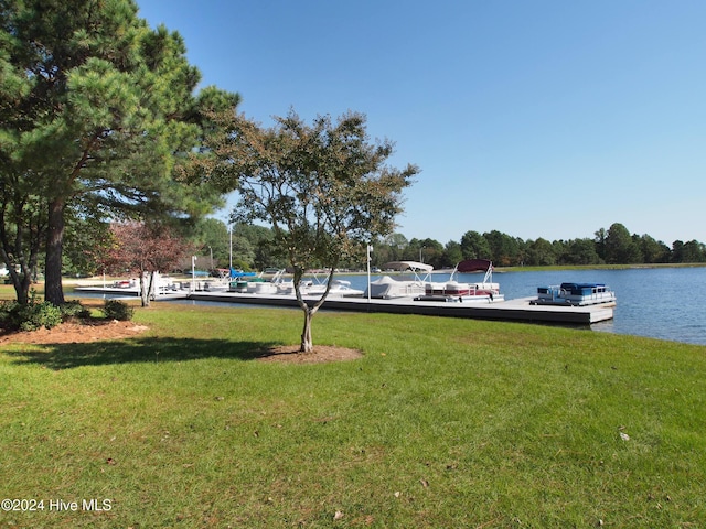 view of yard featuring a dock and a water view