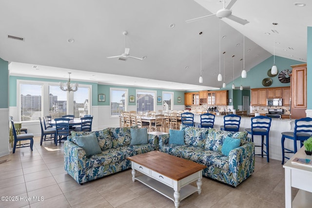 tiled living room featuring high vaulted ceiling and ceiling fan