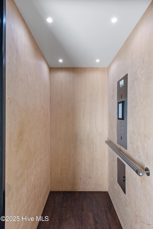 interior space with elevator and dark wood-type flooring