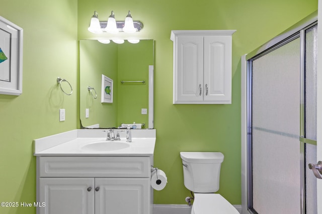 bathroom with toilet, vanity, and walk in shower