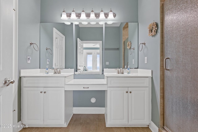 bathroom featuring tile patterned flooring, vanity, and walk in shower