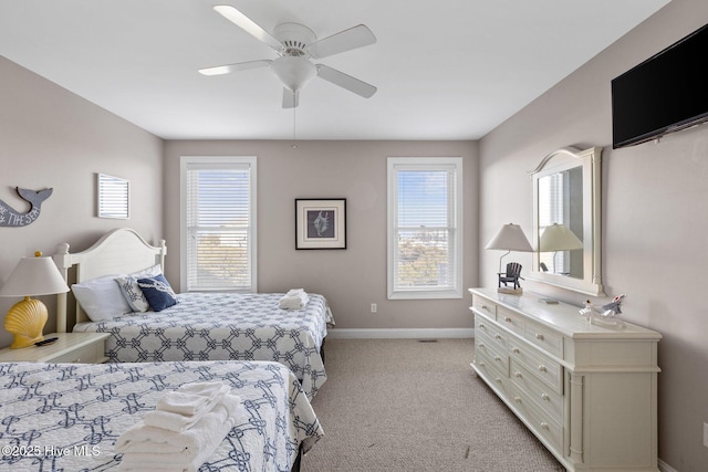 carpeted bedroom with multiple windows and ceiling fan