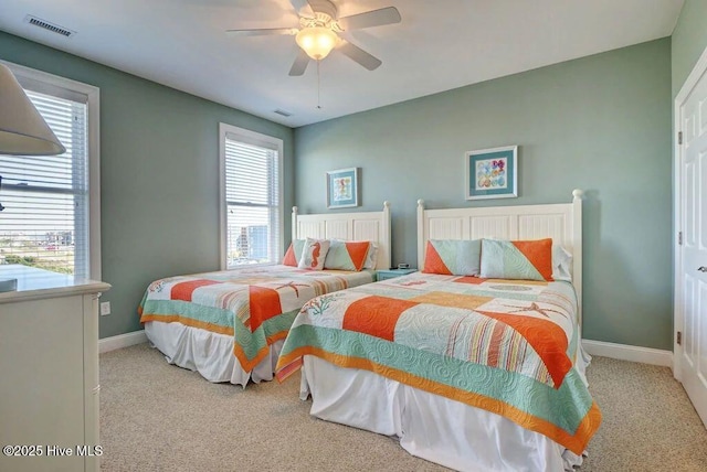 bedroom featuring light colored carpet and ceiling fan