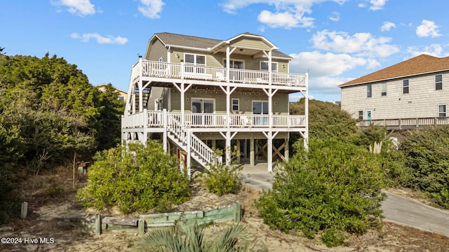 rear view of house featuring covered porch and a carport