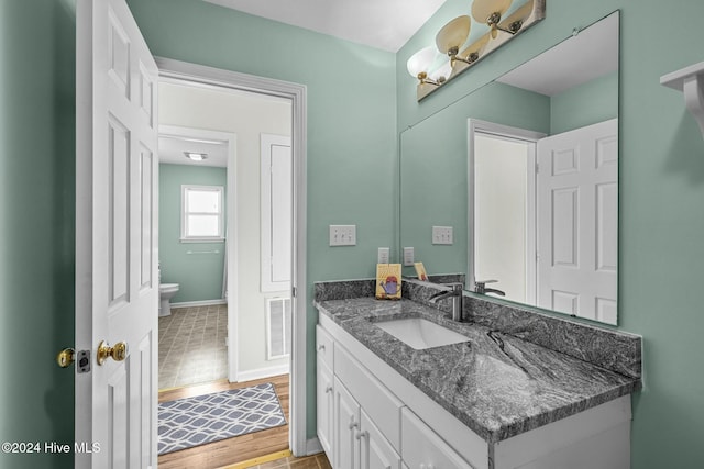 bathroom featuring vanity and toilet