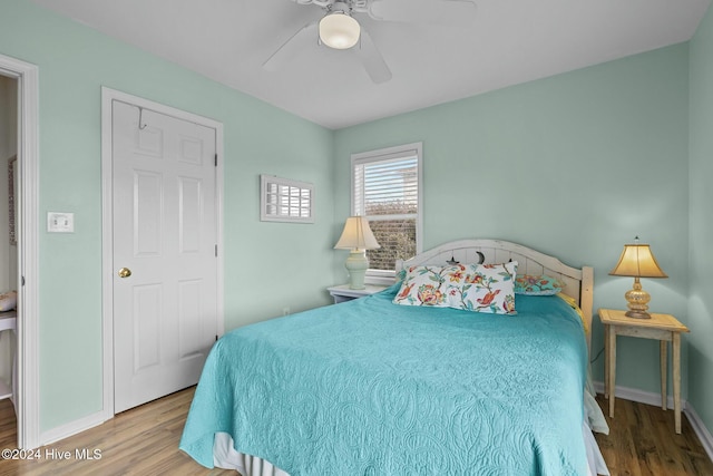 bedroom featuring hardwood / wood-style floors and ceiling fan