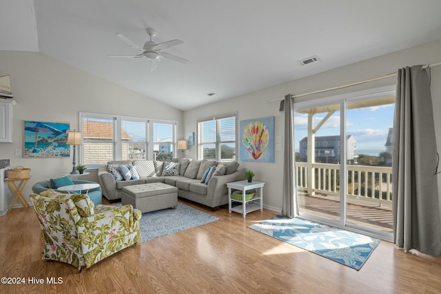 living room with a wealth of natural light, ceiling fan, lofted ceiling, and hardwood / wood-style flooring