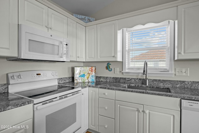 kitchen with white cabinets, white appliances, and sink