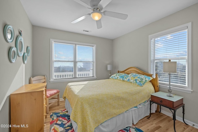 bedroom with light wood-type flooring and ceiling fan