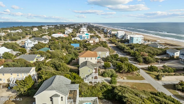 birds eye view of property with a water view and a beach view