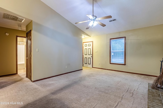 carpeted spare room with ceiling fan and lofted ceiling