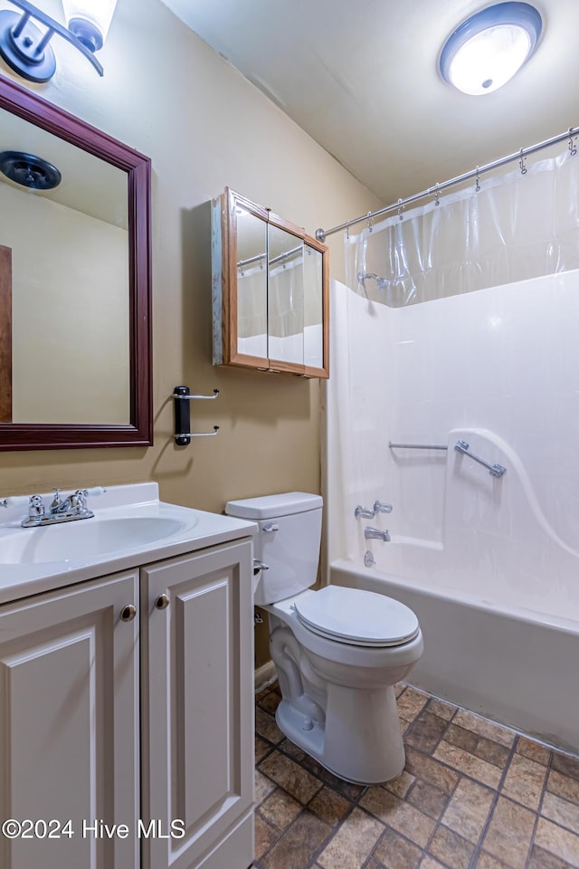 full bathroom with shower / bath combo, vanity, and toilet