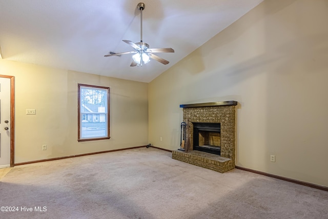 unfurnished living room featuring light carpet, a brick fireplace, ceiling fan, and lofted ceiling