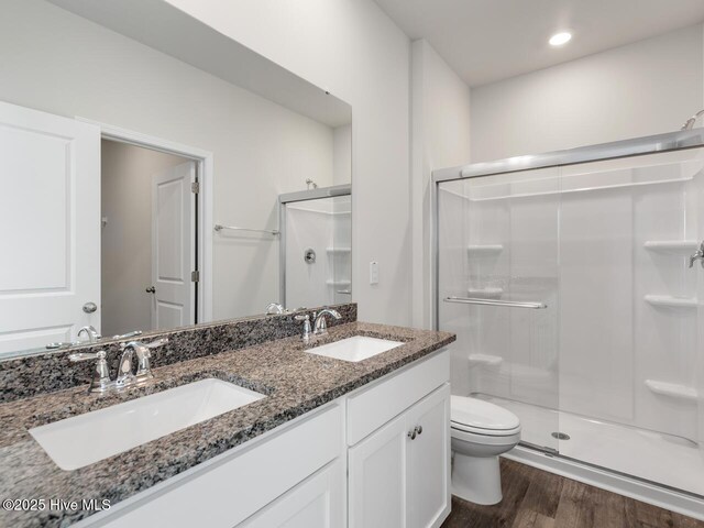 194 N Atlantic Ave Lot 128, Wilmington, NC 28411 - bathroom with a stall shower, wood finished floors, toilet, and a sink
