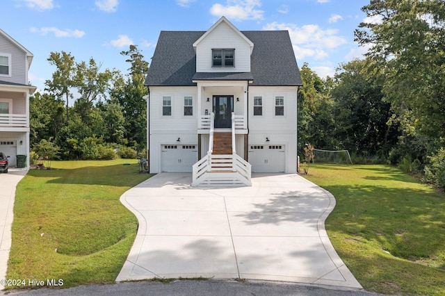 view of front of property featuring a front lawn and a garage