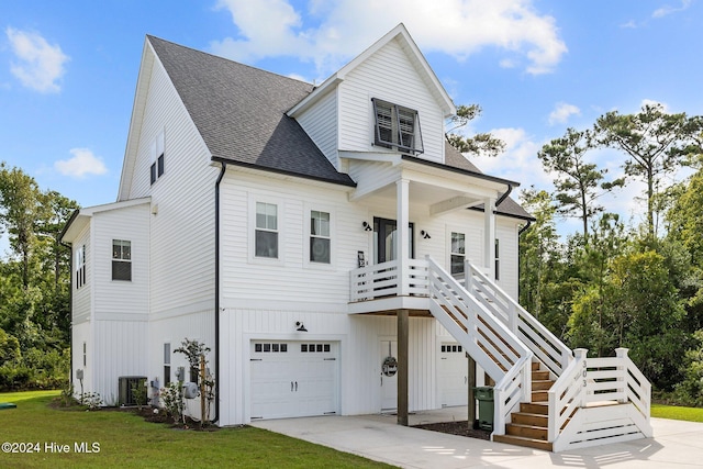 view of front of home featuring cooling unit and a garage