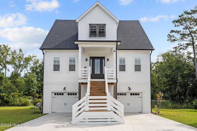 view of front of house with a front lawn and a garage