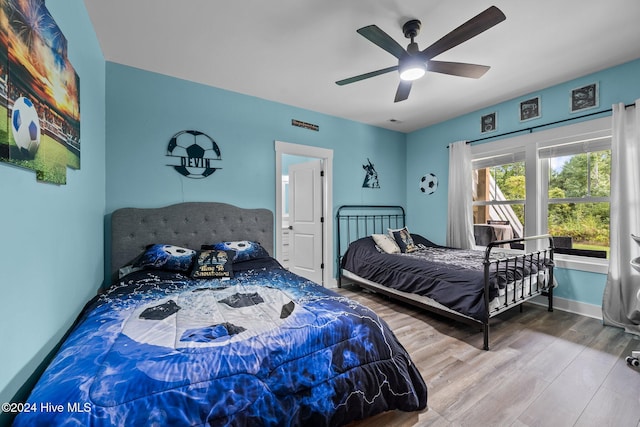 bedroom with hardwood / wood-style floors and ceiling fan