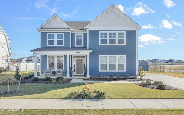 view of front facade featuring a front yard and a porch