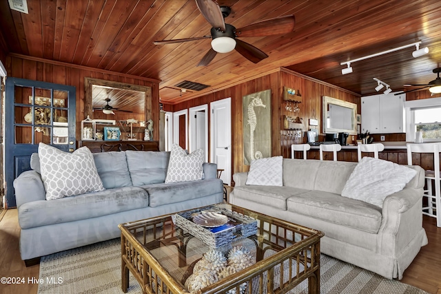 living room with wood ceiling, light wood-type flooring, and wooden walls