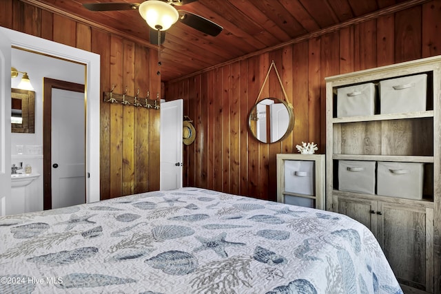 bedroom featuring ensuite bathroom, ceiling fan, wooden ceiling, and wood walls