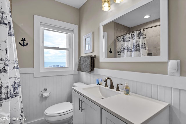 bathroom with curtained shower, vanity, and toilet