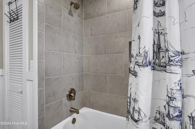 bathroom with shower / bath combo with shower curtain