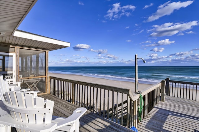 deck with a water view and a beach view