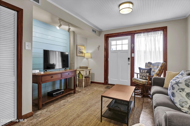 living room with crown molding and track lighting