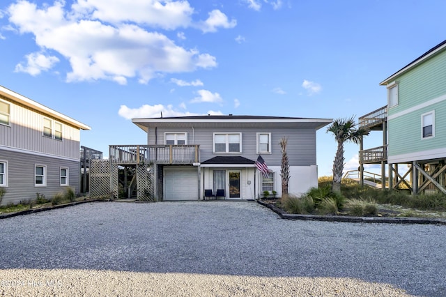 view of front property with a garage and a deck