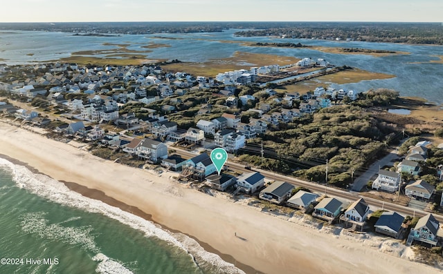 bird's eye view featuring a water view and a beach view