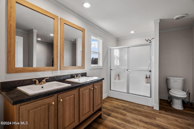 bathroom with an enclosed shower, toilet, hardwood / wood-style flooring, vanity, and ornamental molding