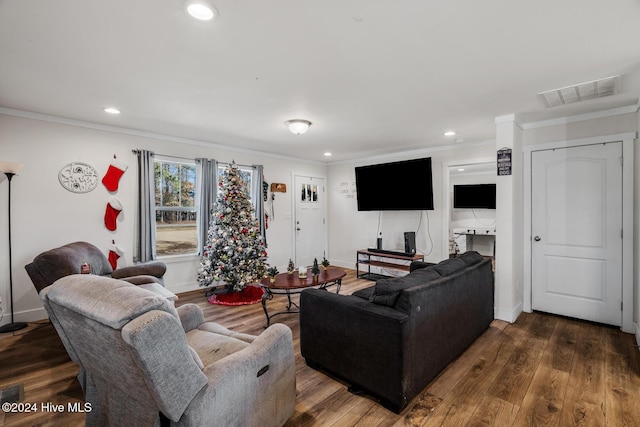 living room featuring dark hardwood / wood-style flooring and ornamental molding